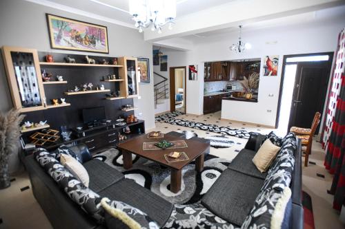 a living room with a couch and a table at Villa Solitude in Berat