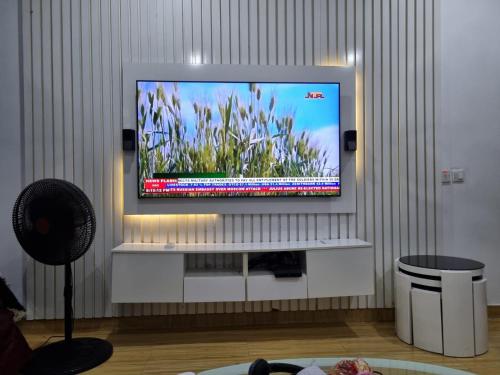 a flat screen tv on a wall in a living room at Pentagon Court Phase 1 Apartment Ikota in Lagos