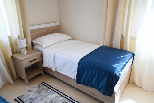 a small bedroom with a bed and a night stand with a nightstand at Villa Solitude in Berat