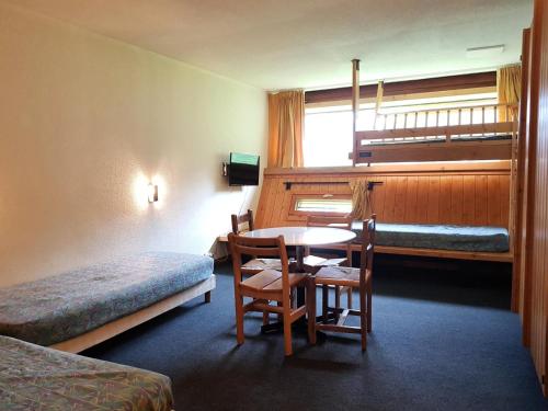 Habitación con mesa, cama y literas. en Résidence Cascade - Studio pour 4 personnes à Arc 1600, ski aux pieds et proche des commerces MAE-1968, en Arc 1600