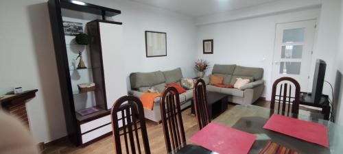 een woonkamer met een bank en een tafel en stoelen bij Piso centro Ciudad Rodrigo cercano a la plaza in Ciudad-Rodrigo