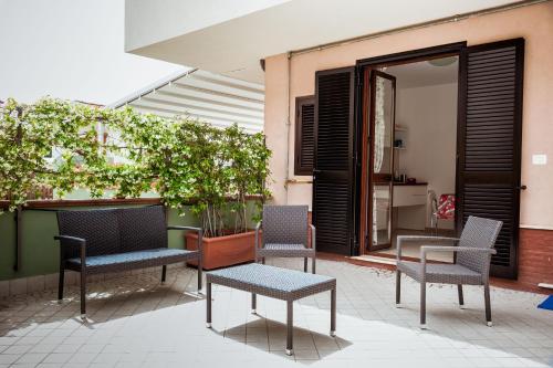 a group of chairs and tables on a patio at Settessenze Residence & Rooms in Agropoli