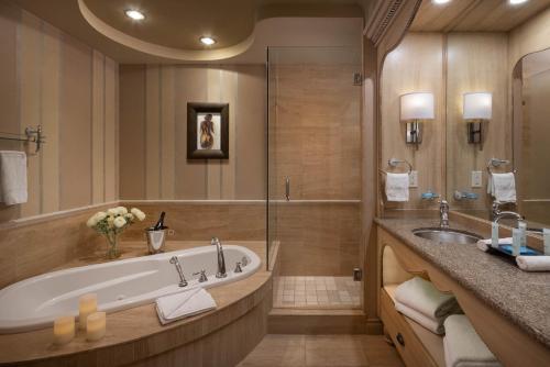 un ampio bagno con vasca e lavandino di The Royal Kelowna - Bellstar Hotels & Resorts a Kelowna