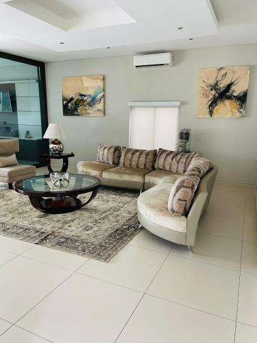 a living room with two couches and a coffee table at Lulanipho Abode in Hartbeespoort