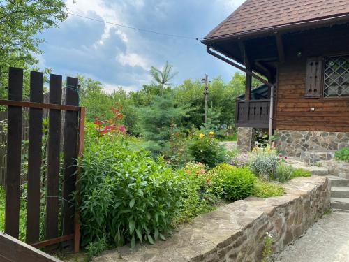 a wooden fence in front of a garden at Садиба Остра in Sherbovtsy