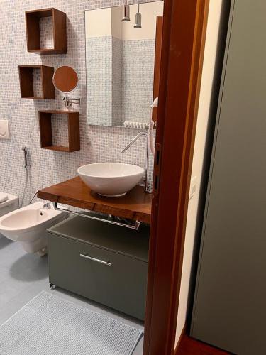 a bathroom with a sink and a toilet at Coco Apartment in Bergamo