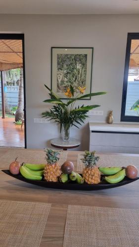 a plate of fruit on a table in a room at Raahere Lodge - near the city center in Papeete