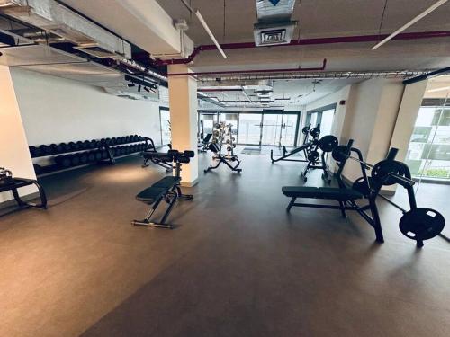 a gym with cardio equipment in a large room at Dutch Luxury Apartment - Private Beach in Abu Dhabi