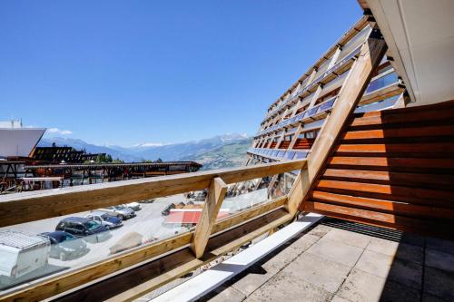 a balcony of a cruise ship with a view of a marina at Résidence Les Arolles - Studio cabine 5 personnes agréable et bien aménagé à Arc 1600 en centre station et proche des pistes MAE-2139 in Arc 1600