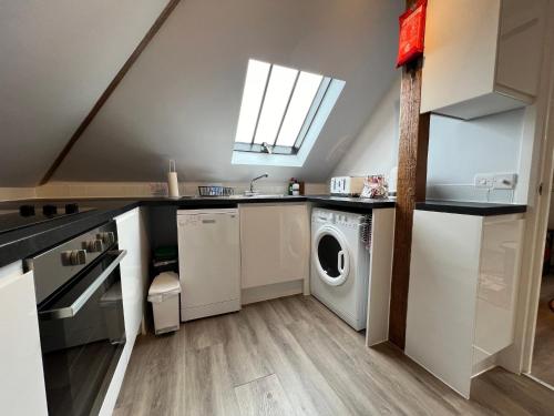 a kitchen with a washer and dryer in it at Glastonbury Secret Retreat - 1 BD Split-Level Apt, Sleeps 3 in Glastonbury