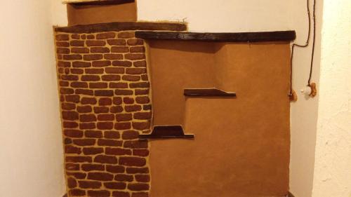 a brick wall with two shelves on top of it at B&B Santu Giuvanni "Un tuffo nel passato Fonnese" in Fonni