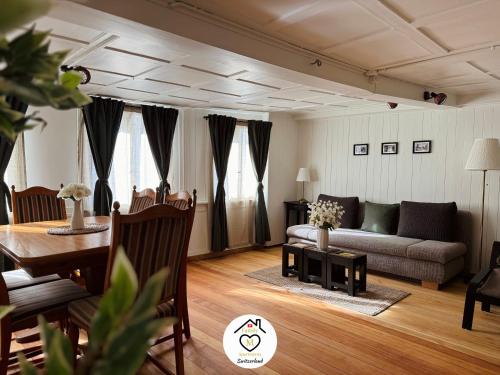a living room with a couch and a table at Family M Apartments 16-17-18 in Sempach