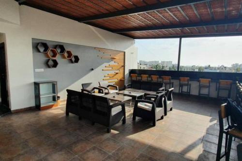 a dining room with tables and chairs and a staircase at 11. 101@HSR Premium Fully Furnished 1BHK Flat in Bangalore