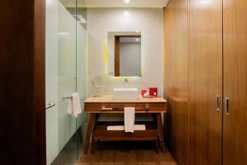 a bathroom with a sink and a mirror at The Fives Downtown Hotel & Residences, Curio Collection by Hilton in Playa del Carmen