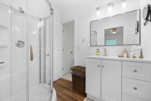a white bathroom with a shower and a sink at 29 Palms in Anna Maria