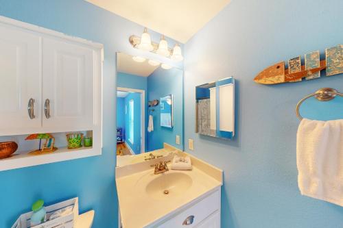 a bathroom with a sink and a mirror at Gulf Breeze Getaway in Saint Joe Beach