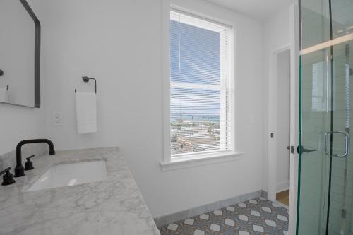 a bathroom with a sink and a window at Norblad Hotel in Astoria, Oregon