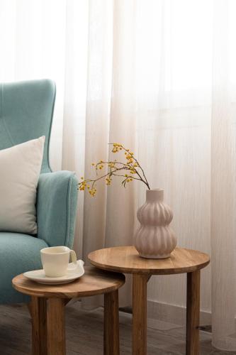 a table with a vase on it next to a chair at Mytakas Houses in Mytakas