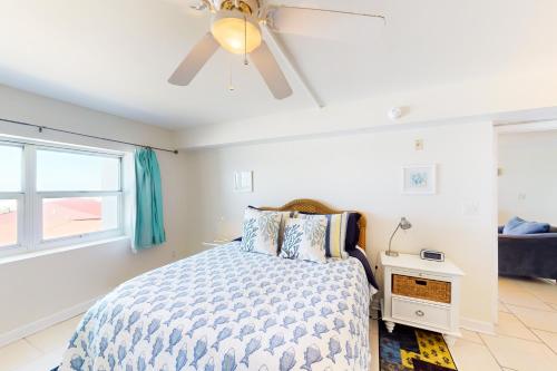 a bedroom with a bed and a ceiling fan at Regency Towers W 707 in Pensacola Beach