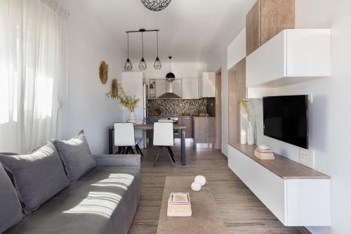 a living room with a couch and a kitchen at Mytakas Houses in Mytakas