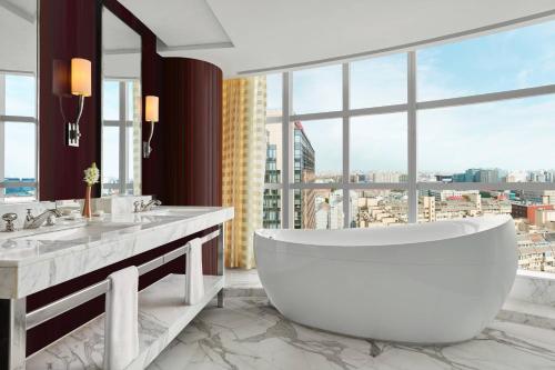 a bathroom with a tub and a large window at The Ritz-Carlton Beijing, Financial Street in Beijing