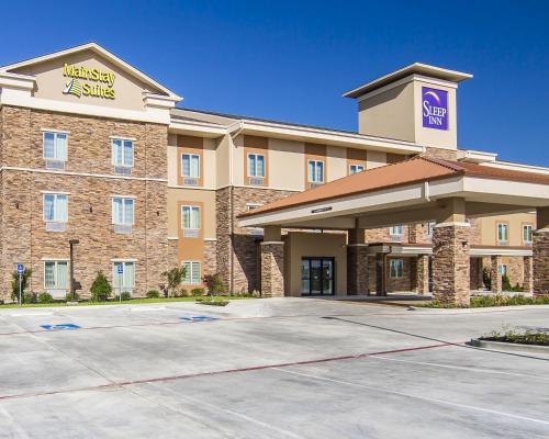 a front view of a hotel with a parking lot at Sleep Inn Lufkin in Lufkin