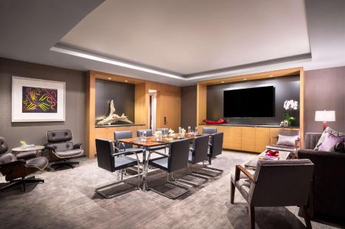 a conference room with a table and chairs and a television at Conrad New York Downtown in New York