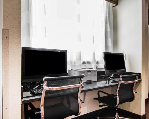 a desk with a computer and a laptop on it at Sleep Inn Lufkin in Lufkin