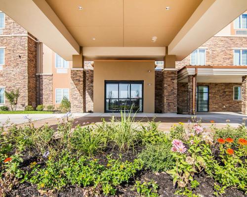 a front view of a building with flowers at Sleep Inn Lufkin in Lufkin
