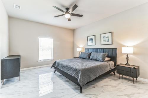 a bedroom with a bed and a ceiling fan at Three-Bedroom House in Lehigh Acres