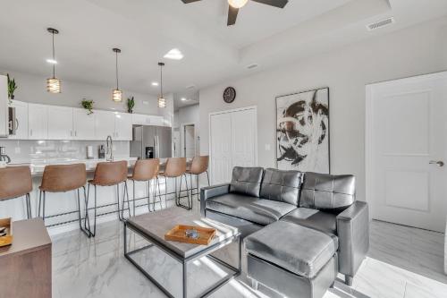 a living room with a couch and a table at Three-Bedroom House in Lehigh Acres