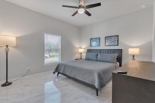 a bedroom with a bed and a ceiling fan at Three-Bedroom House in Lehigh Acres