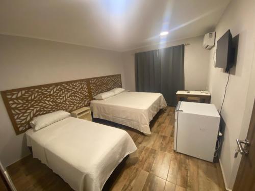 En eller flere senge i et værelse på LOS LIRIOS