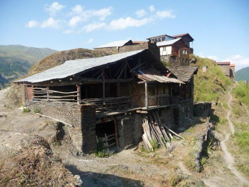 an old house on the side of a mountain at paradise of tusheti in Omalo