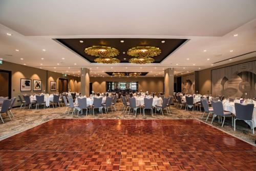 a banquet hall with white tables and chairs at DoubleTree by Hilton Woking in Woking