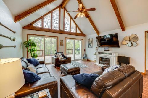 a living room with leather furniture and a fireplace at Versatile Home with Deck and Grill, 1 Mi to Lake! in Pottsboro