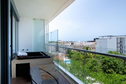 a balcony with a view of a city at The Fives Downtown Hotel & Residences, Curio Collection by Hilton in Playa del Carmen
