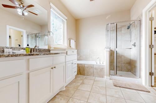 a white bathroom with a shower and a sink at Hidden Springs Oasis in San Antonio