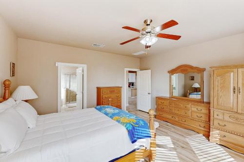 a bedroom with a bed and a ceiling fan at Hidden Springs Oasis in San Antonio