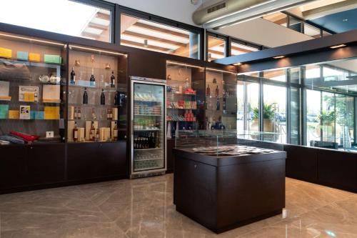 a wine shop with a display case with wine bottles at Doubletree by Hilton Milan Malpensa Solbiate Olona in Solbiate Olona