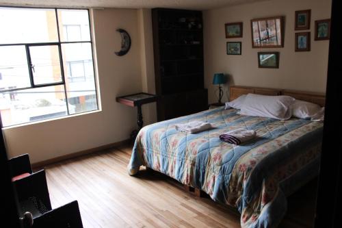 a bedroom with a bed with two pillows on it at Casa de Tulia in Quito