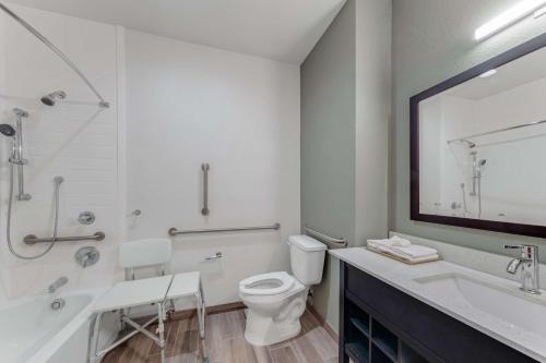 a white bathroom with a toilet and a sink at Americas Best Value Inn San Antonio Downtown Riverwalk in San Antonio