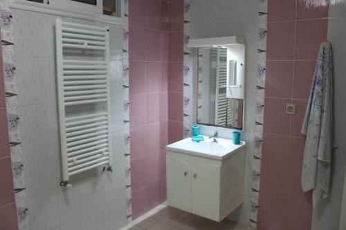a bathroom with a sink and a mirror at Dar Sarra in Sousse