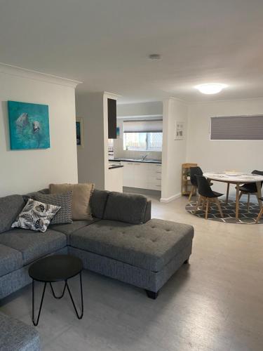 a living room with a couch and a table at Sylvan Seas in Bellara