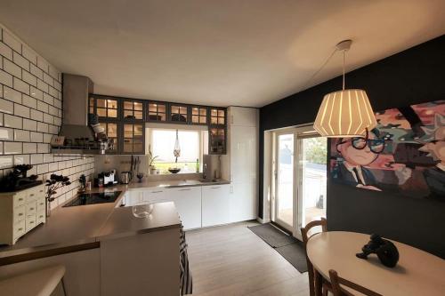 a kitchen with a table and a dining room at Superb and central place! Airb&b favorite in Bergen
