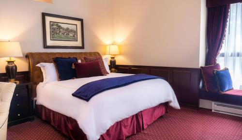 a bedroom with a large bed in a room at Carriage House Inn in Carmel