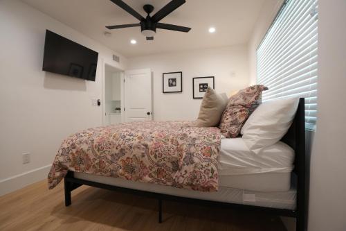 a bedroom with a bed and a ceiling fan at Destination #50 in Placentia