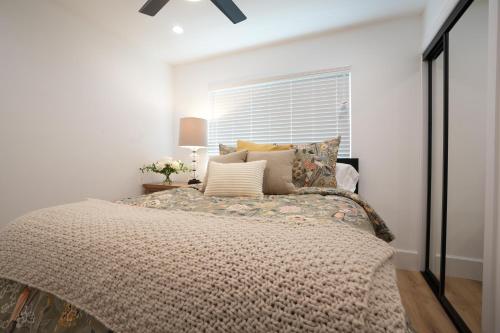 a bedroom with a large bed and a window at Destination #50 in Placentia