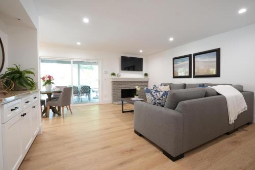 a living room with a gray couch and a table at Destination #50 in Placentia