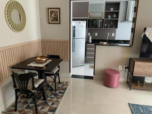 a kitchen and dining room with a table and a refrigerator at Santos Linda!! Apartment for Business and Leisure. in Santos
